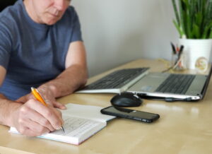 Man is writing in the journal - Image from Inkfire Limited