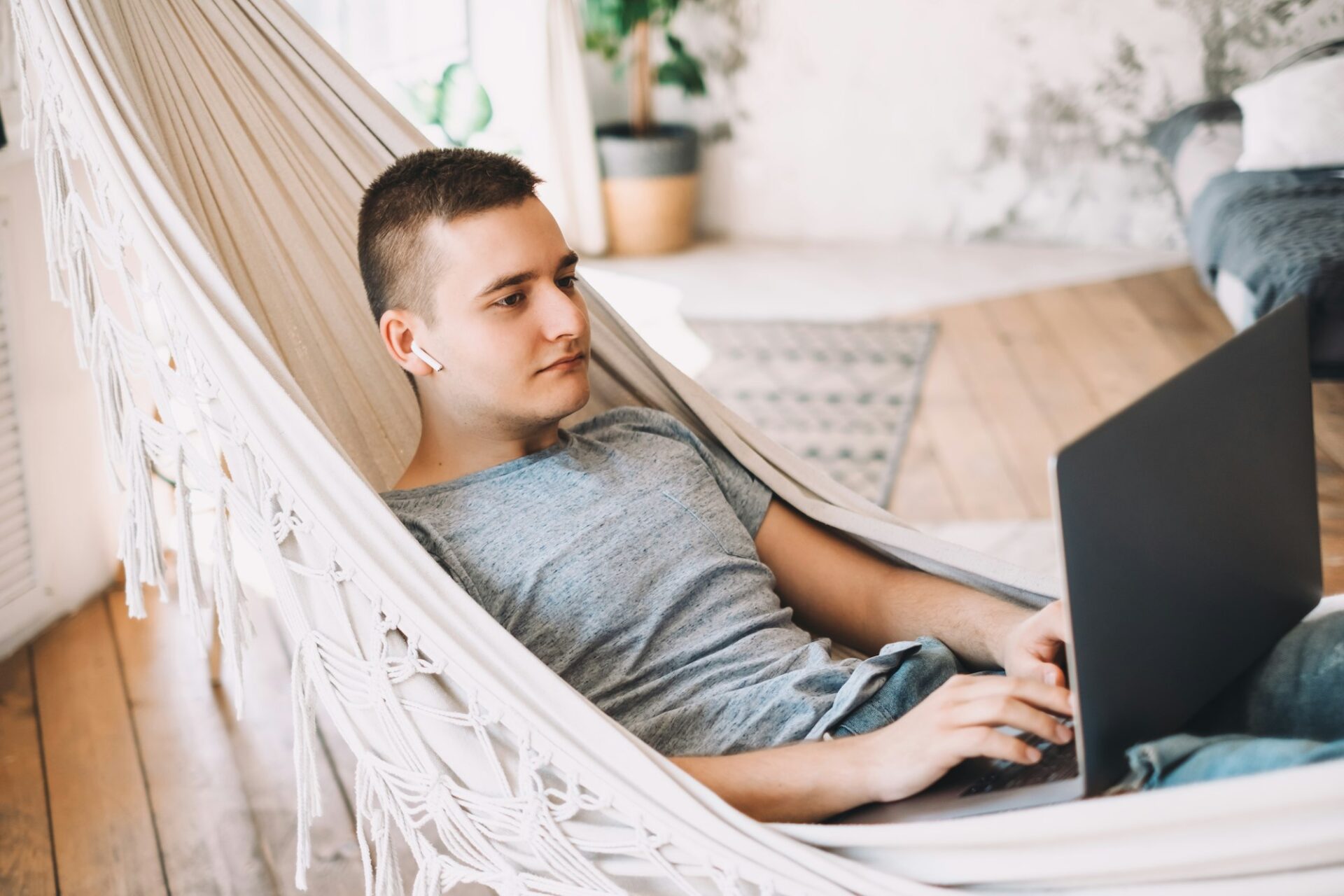 A young caucasian businessman in headphones works on a laptop - Image from Inkfire Limited