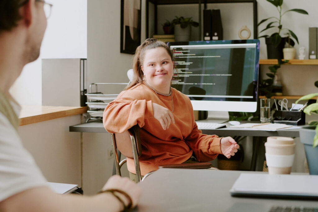 Female programmer looking at coworker 2025 05 13 09 41 59 utc scaled 1 - Image in article: Back To Work Scheme: Empowering Disabled Talent Through Real-World Experience